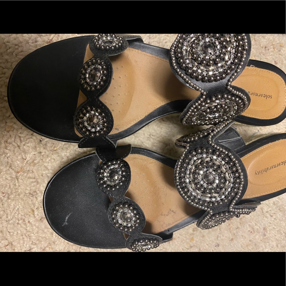 Black sandals w sparkly detailing.